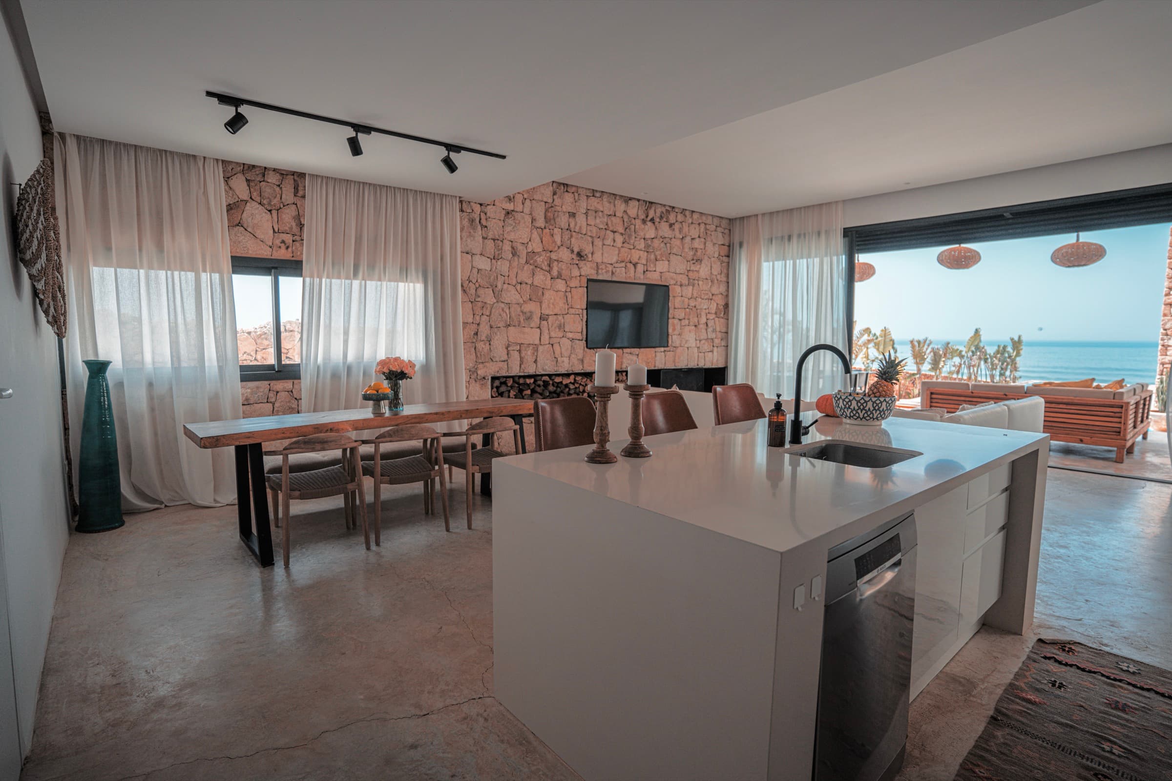 Equipped kitchen with central island, ocean beyond